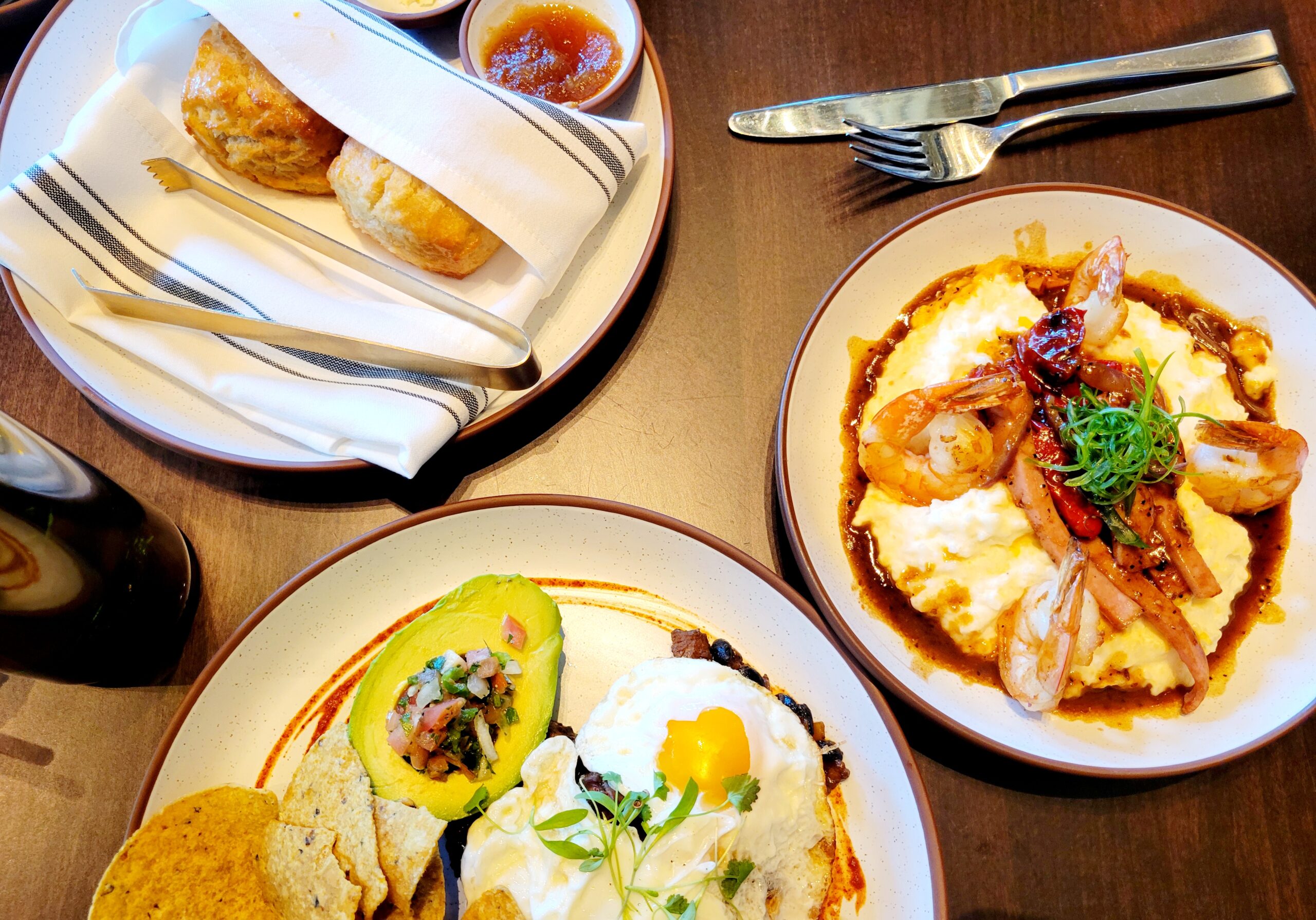 table with biscuits, shrimp and grits and eggs