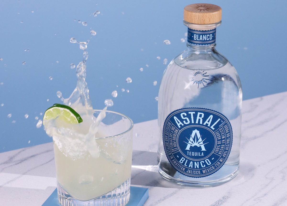 blue background with bottle of astral tequila and margarita