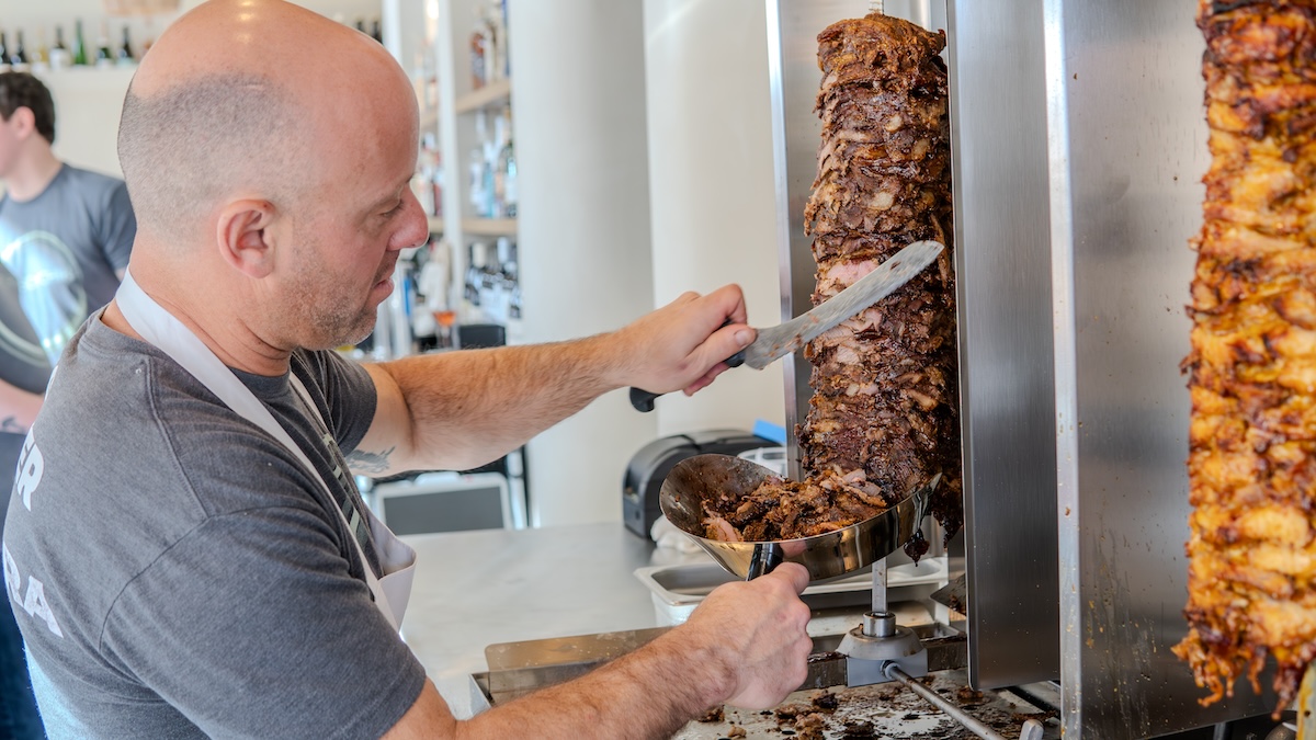 white man carving gyro or donna