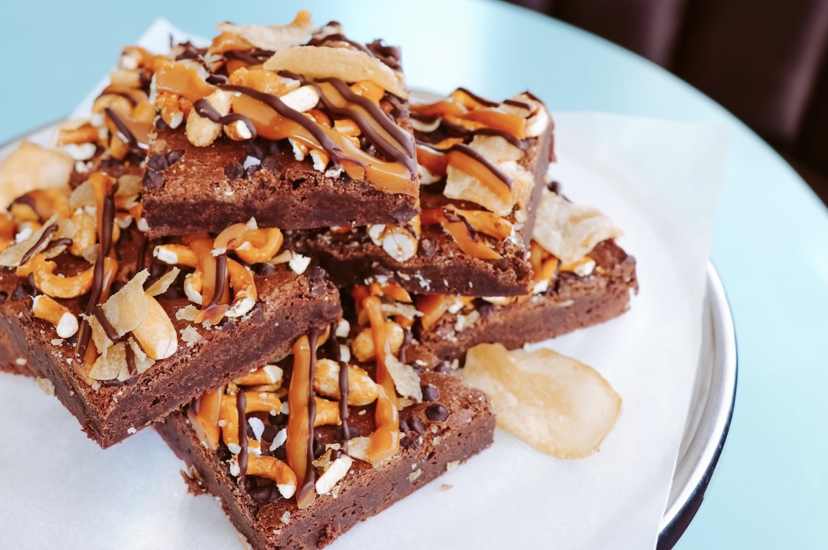 white plate on blue table with brownies