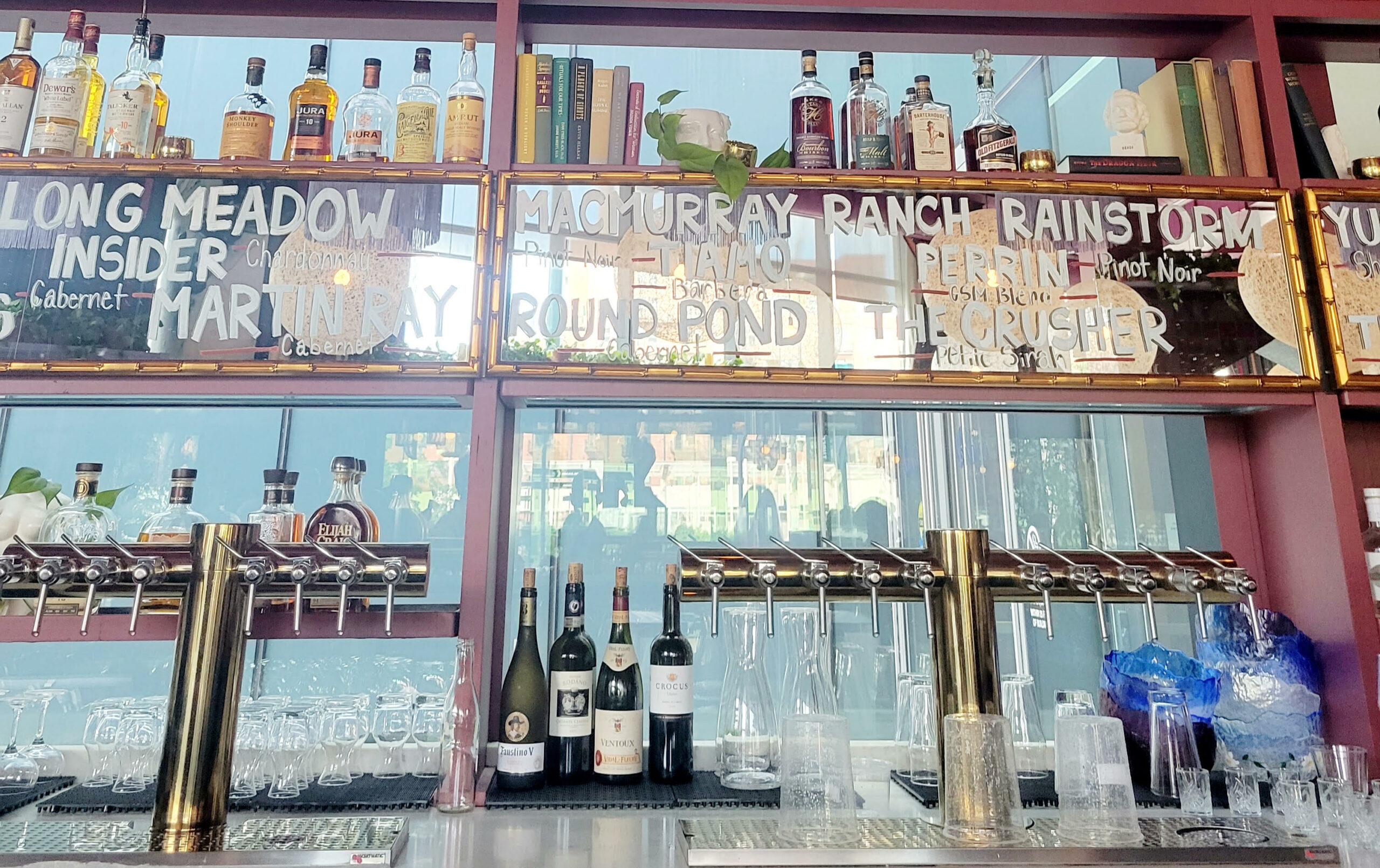 mirrored wall with taps and wine