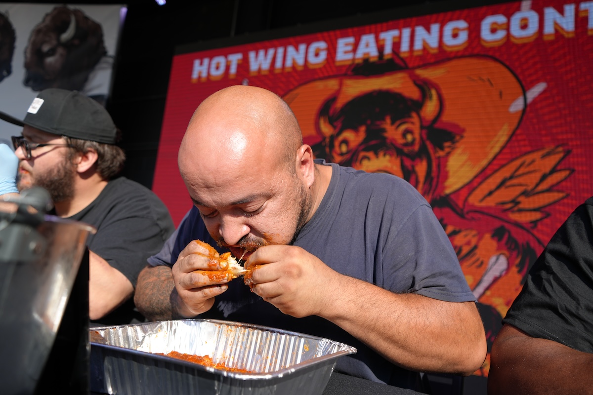 Sergio Atencio won by eating 10 super hot wings in just over three minutes. | Photo by Kevin Fox