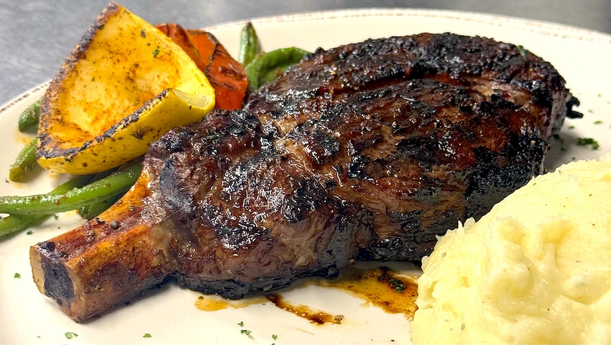 Bastien's Bone-In Ribeye Bone-in rib-eye is a large and succulent cut. | Photo by Bastian's