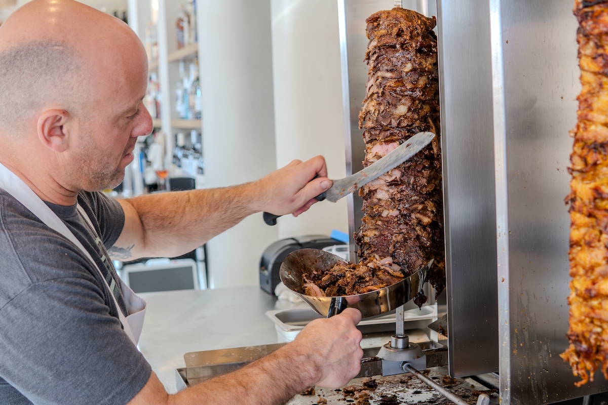 Chase_Devitt_boychik_meat Chase Devitt carves meat at Boychik, his three-restaurant company. | Photo by Boychik