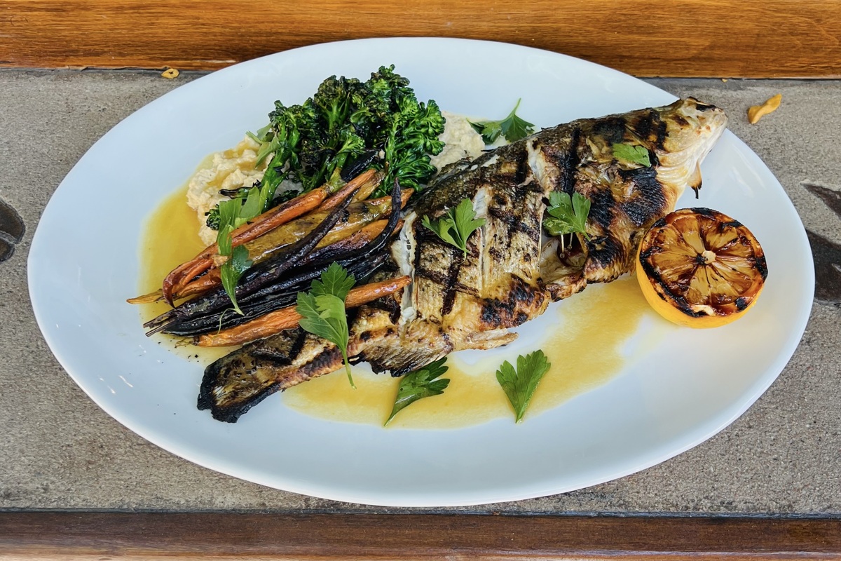 Jax_Fish_House_and_Oyster_Bar_Whole_Grilled_Alamosa_Striped_Bass Grilled striped bass sourced from Alamosa | Photo by Jax Fish House & Oyster Bar