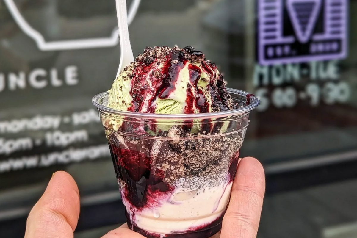 right cream Cup of My Neighbor Totoreo with matcha ice cream, Oreo toffee, and blueberry jam, held up in front of the Right Cream storefront window.