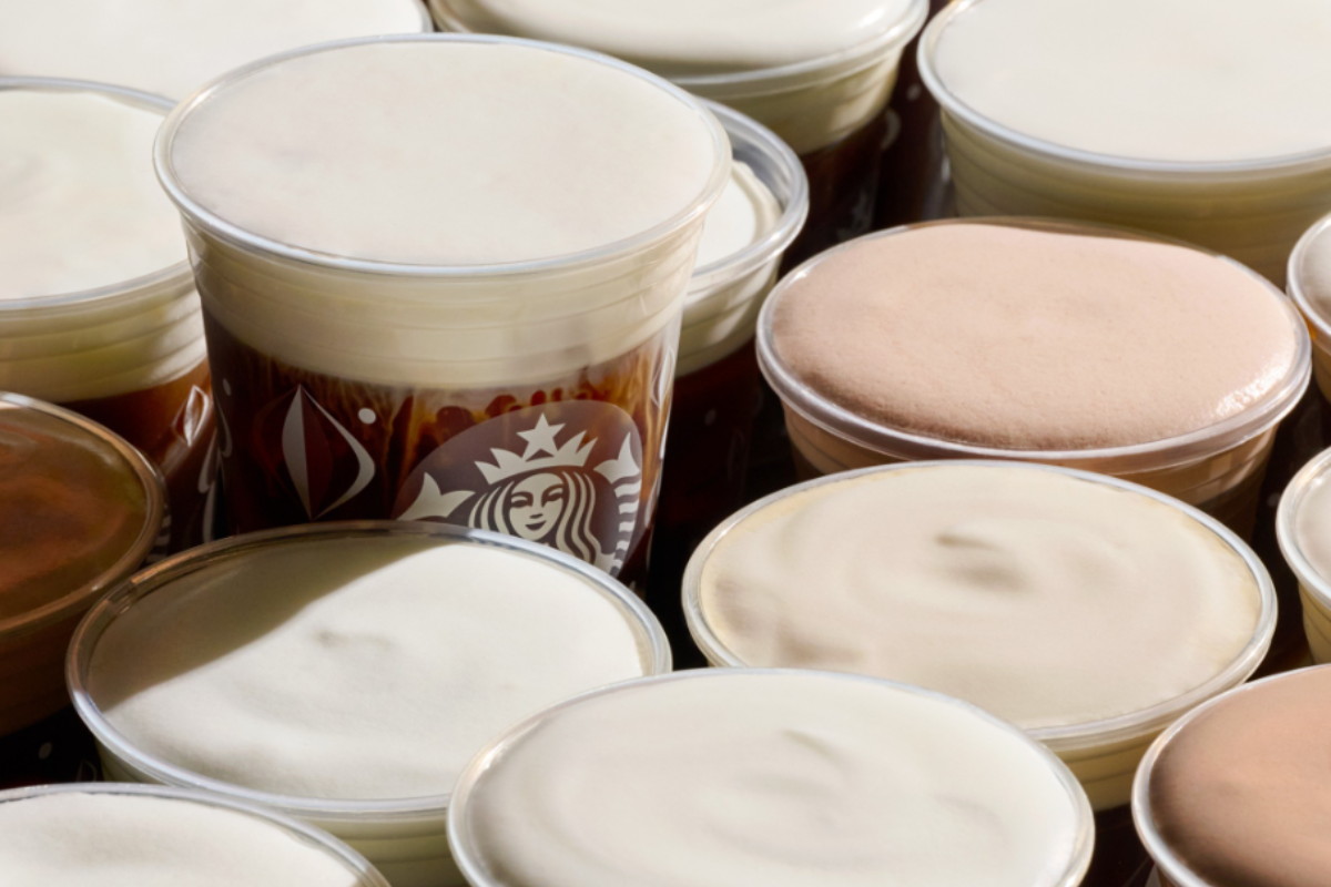 starbucks coffee Starbucks cold brew drinks topped with layers of creamy foam, shown in clear cups with the Starbucks logo, packed tightly together in a close-up shot.