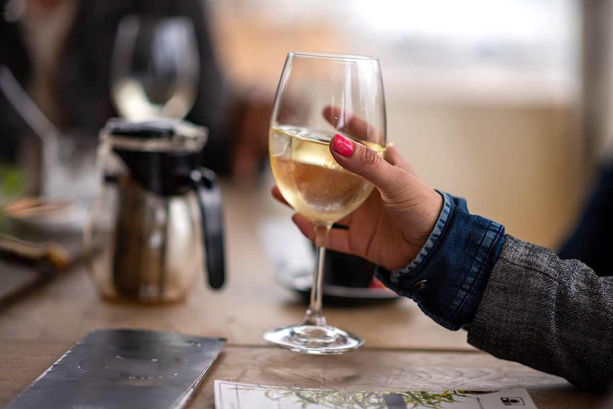 Close up shot of woman holding glass of wine It's never a bad idea to have a glass of wine before a flight.
Stock Image
