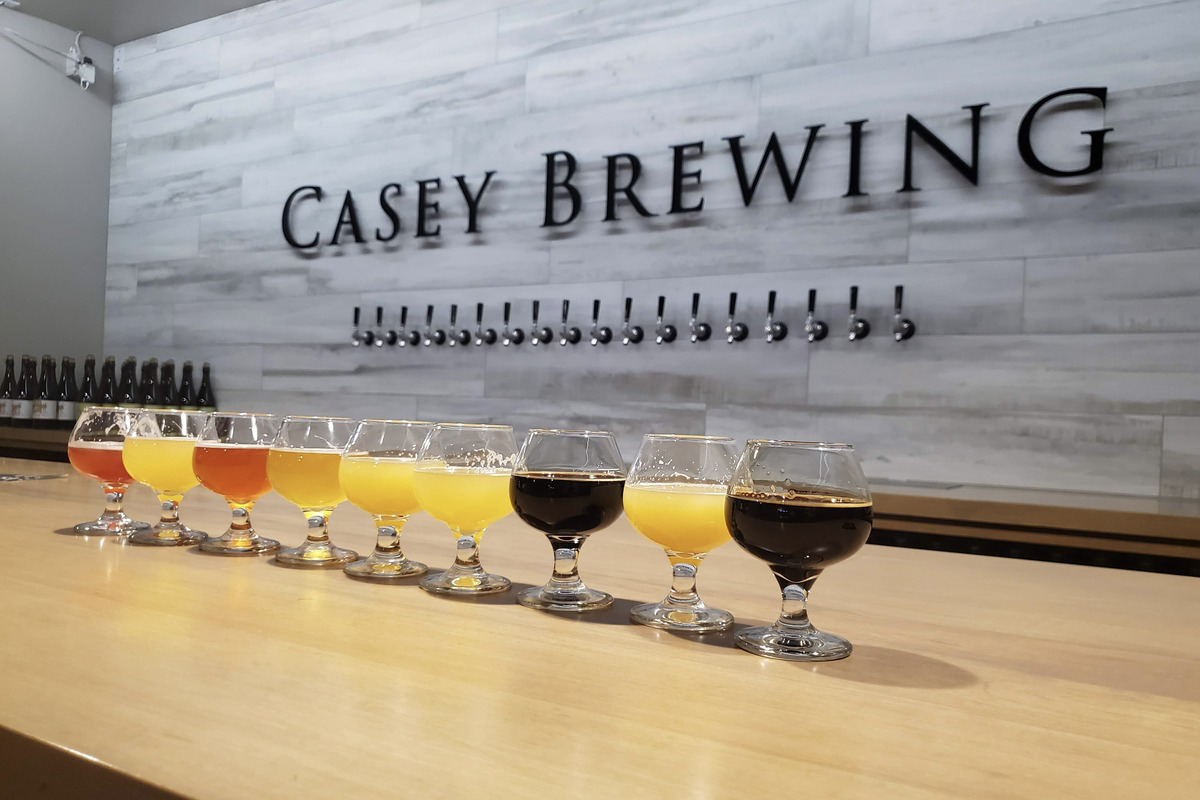 Casey_Brewing Flight of craft beers at Casey Brewing in Glenwood Springs, Colorado, featuring a colorful range of styles in stemmed glasses lined up on the bar.