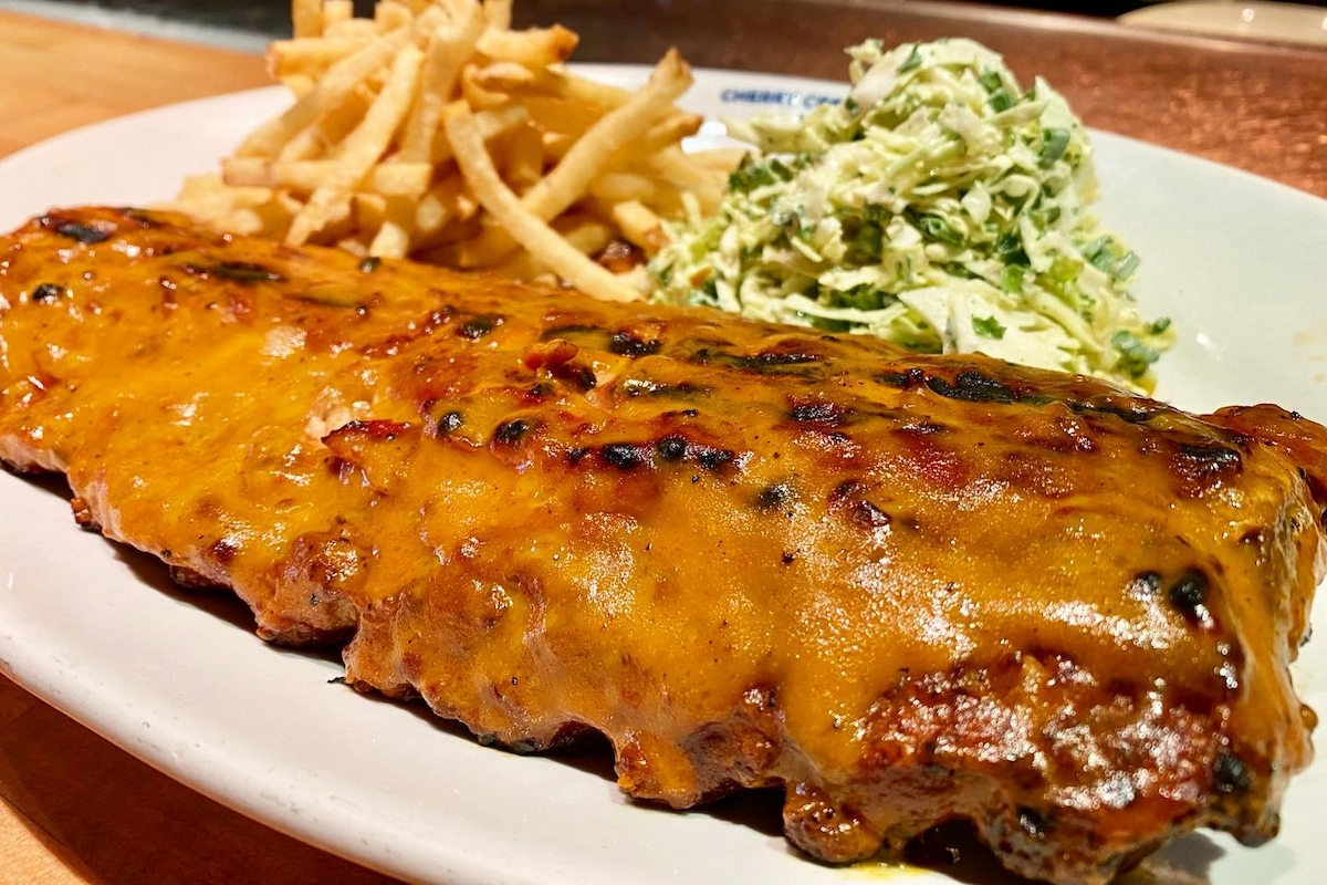 Cherry Creek Grill Barbecue ribs with golden glaze served with French fries and creamy slaw at Cherry Creek Grill in Denver.