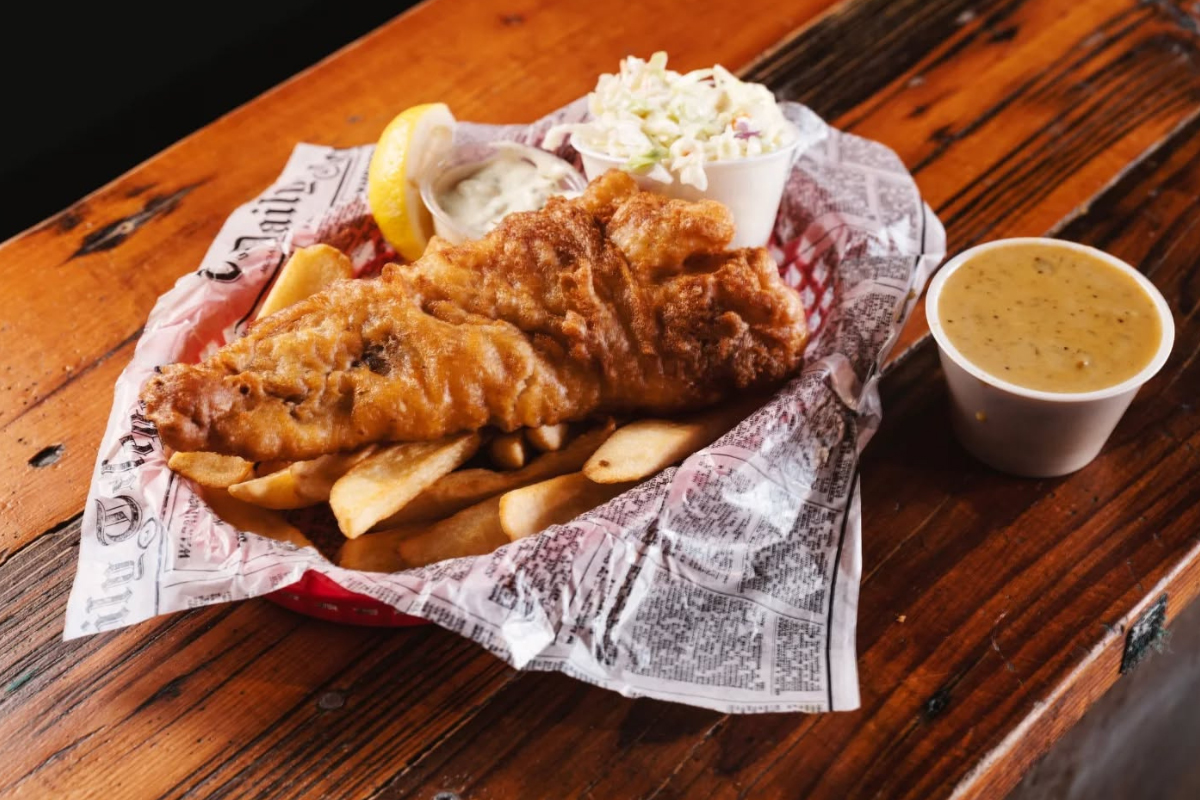 gb fish chips Basket of fish and chips served with coleslaw, tartar sauce, and lemon wedges at GB Fish & Chips in Denver.