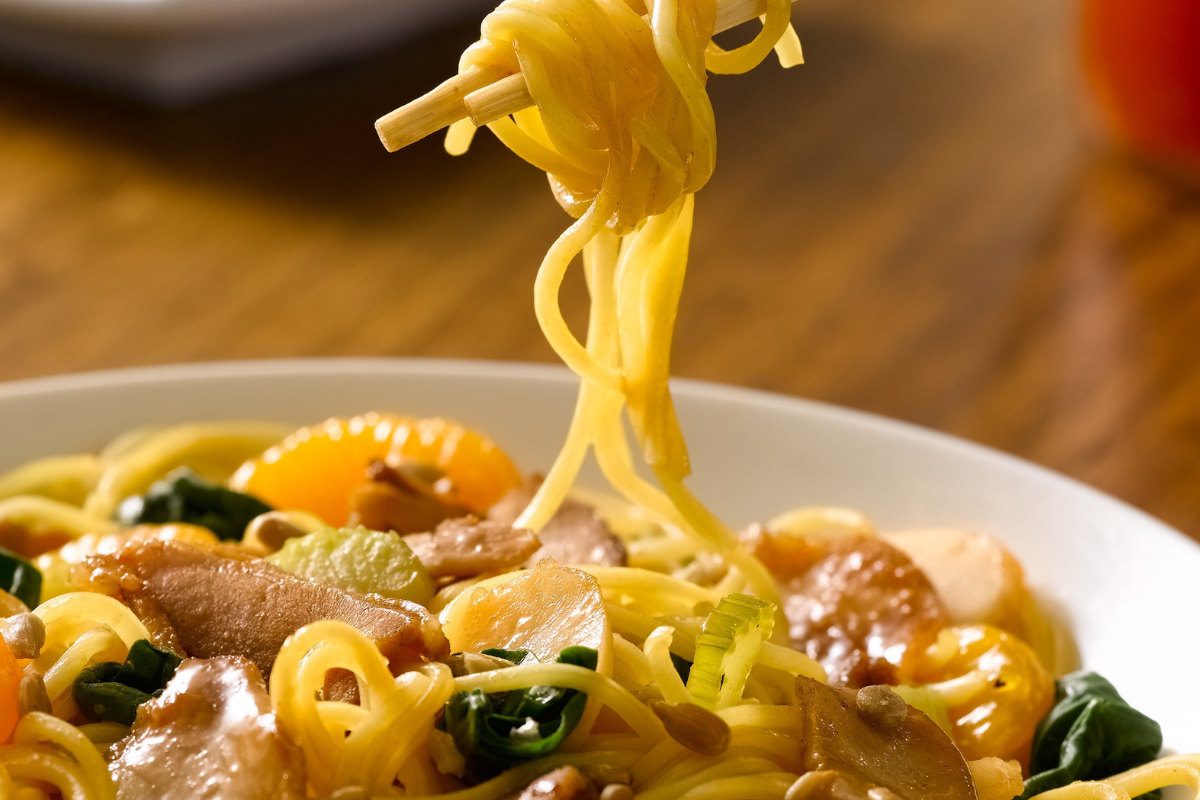 huhot Stir-fried noodles with sliced meat, vegetables, and mandarin oranges at HuHot Mongolian Grill in Denver.