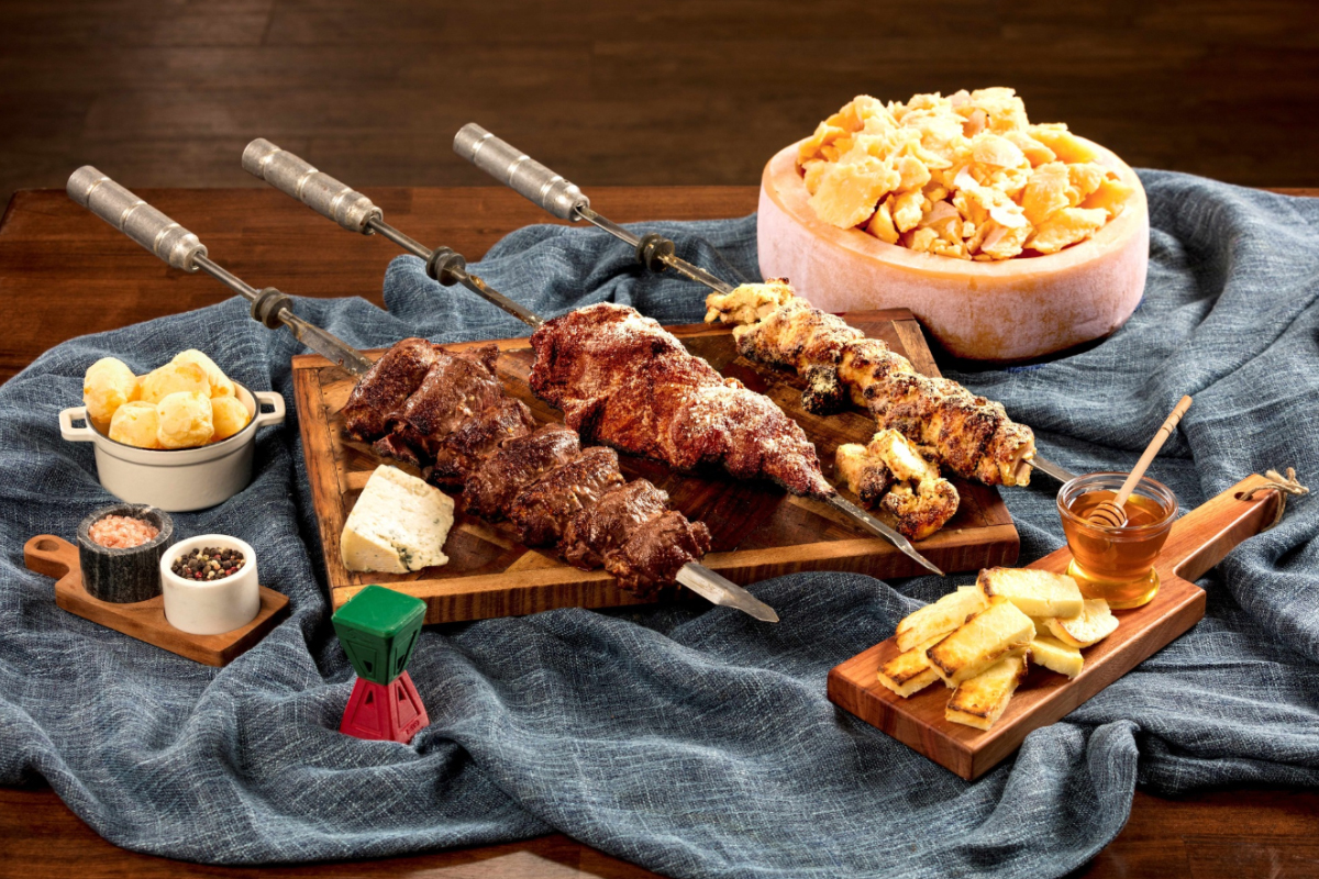 rodizio grill Churrasco-style grilled meat skewers, Brazilian cheese bread, grilled pineapple, and dipping sauces at Rodizio Grill in Denver.