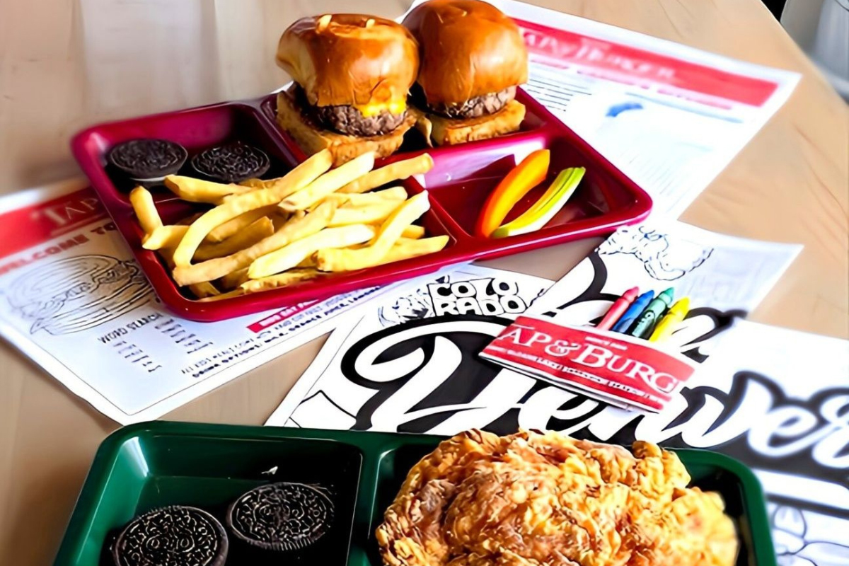 tap burger Kids meal trays with cheeseburger sliders, fried chicken, fries, cookies, and veggie sticks at Tap & Burger in Denver.