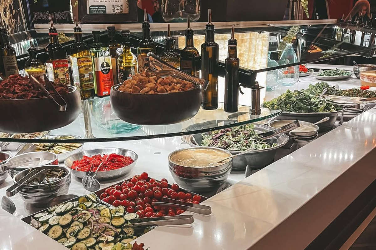 texas de brazil Salad bar with fresh vegetables, toppings, dressings, and oils at Texas de Brazil in Denver.
