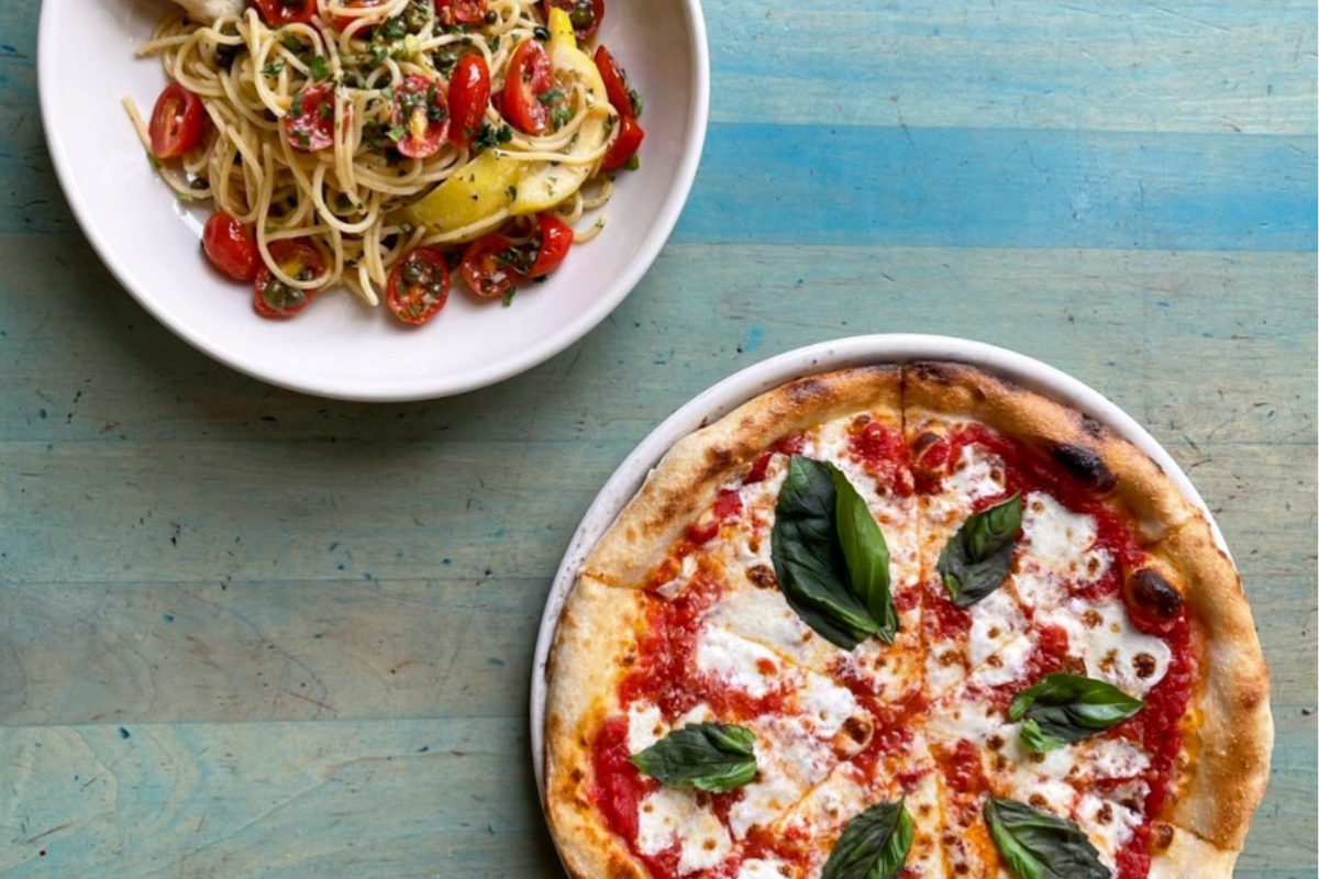 via baci Margherita pizza and a plate of spaghetti with cherry tomatoes at Via Baci in Lone Tree.