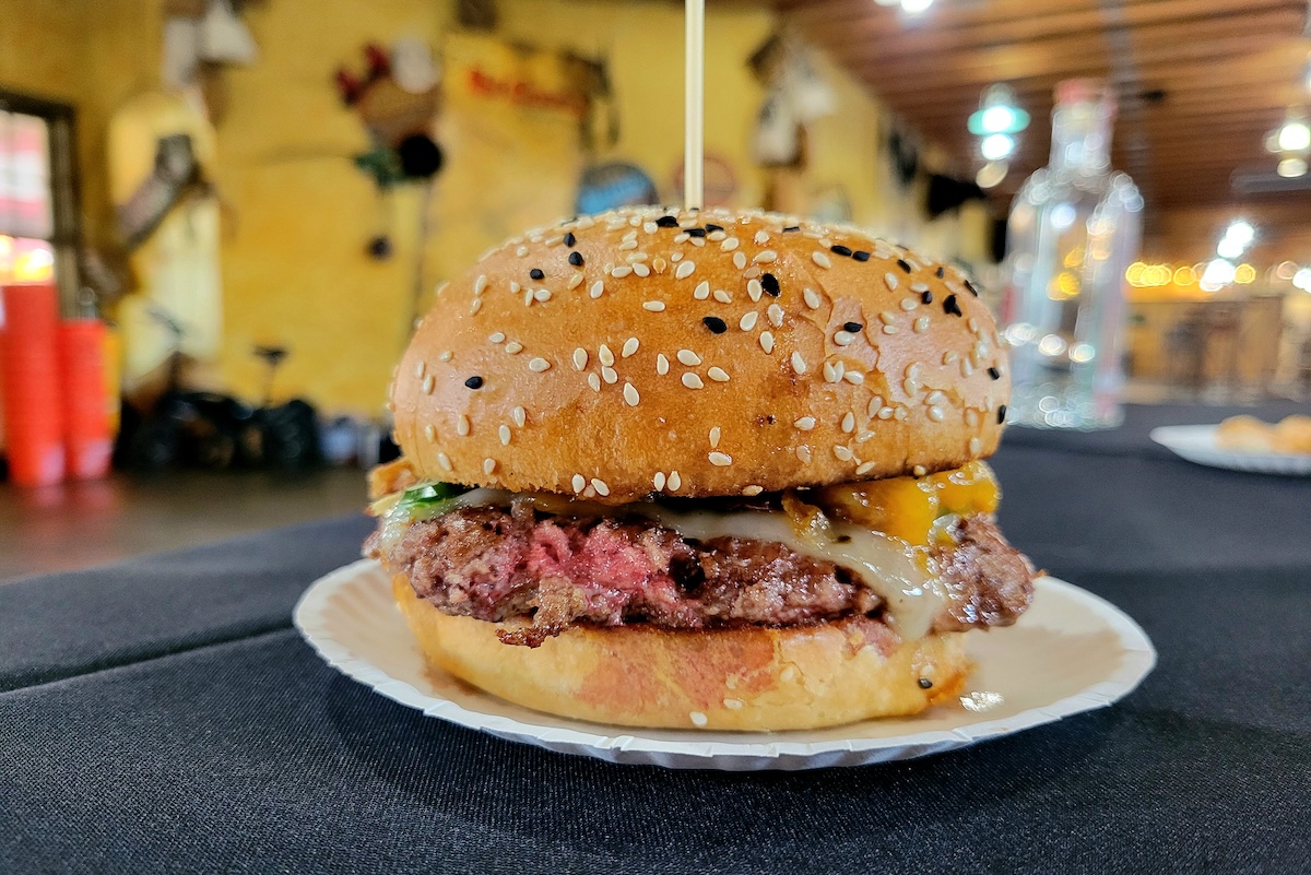 Tap_burger_peach_chicken_fight_2025 The peach burger from Tap & Burger during Burger Balooza. | Photo by Linnea Covington