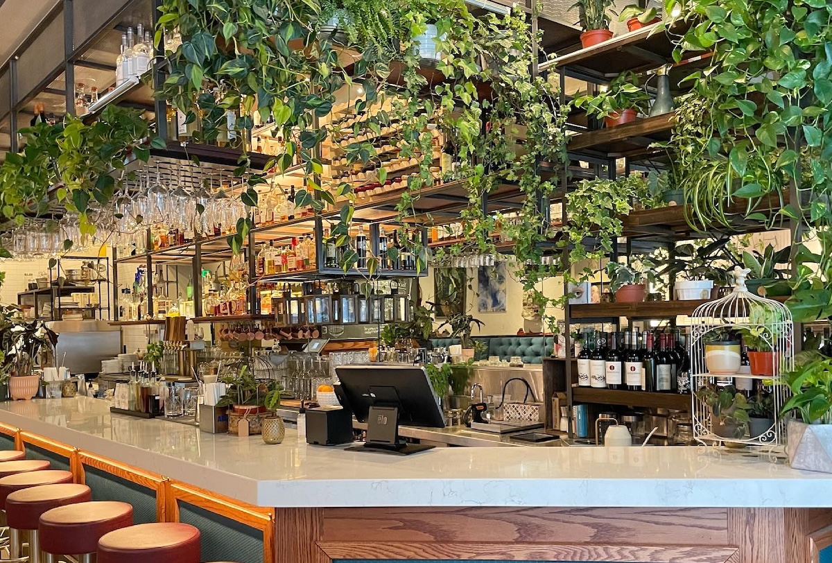 Plants make this gorgeous bar stand out. | Photo by Broken Cage