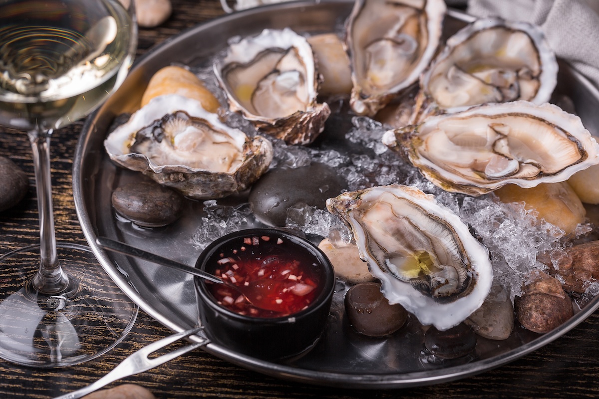 fresh open ready to eat oysters on a plate with ice fish restaurant