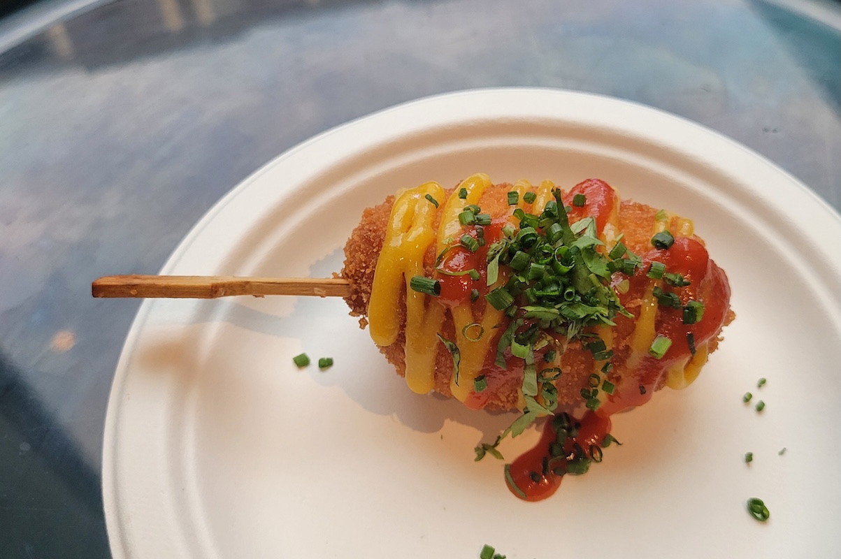 Salt Water Social's shrimp corn dog with peach mustard and spicy ketchup. | Photo by Linnea Covington