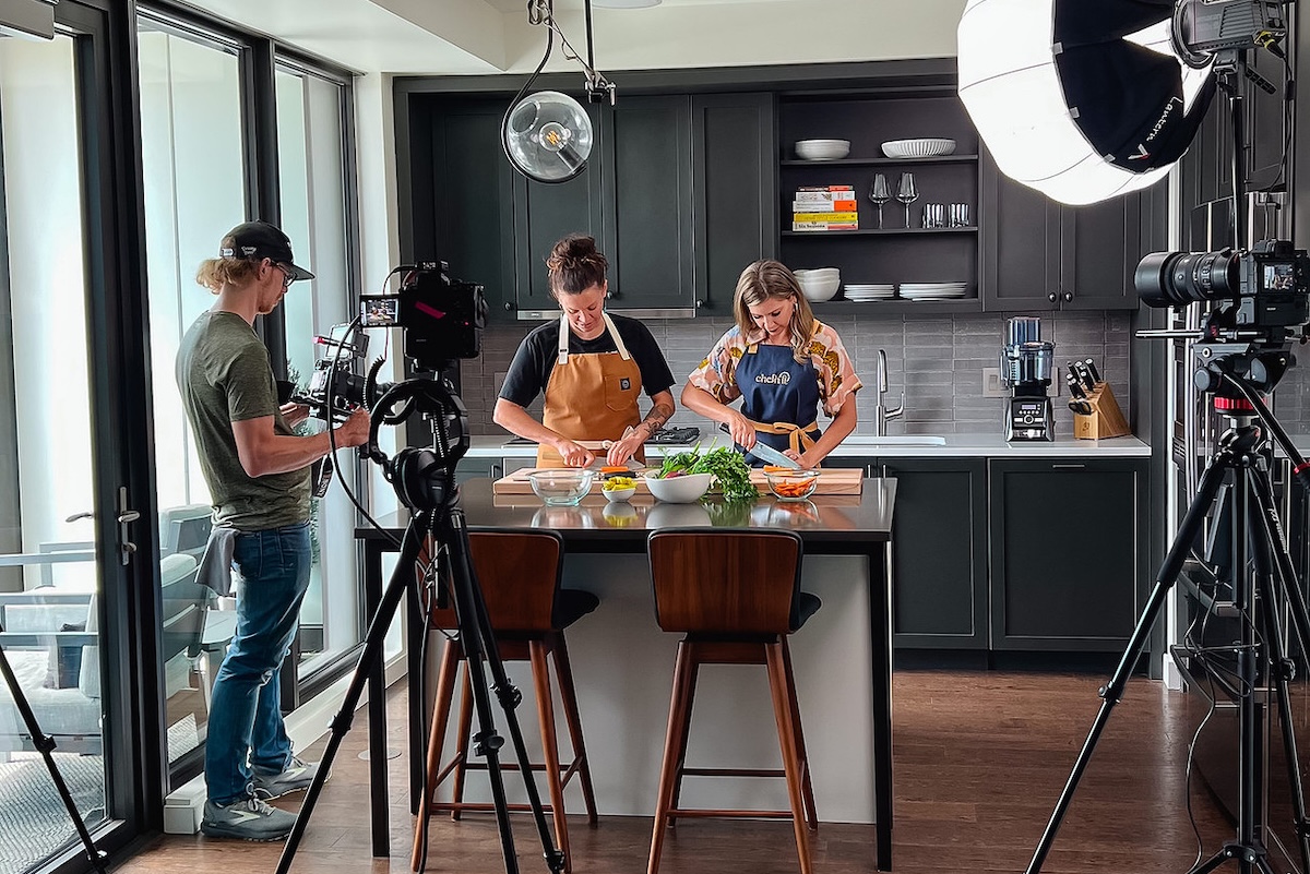Filming Chefn It with Carrie Baird and Tarah Runco_01 Working hard in the kitchen for the show. | Photo by Behind the Apron Media