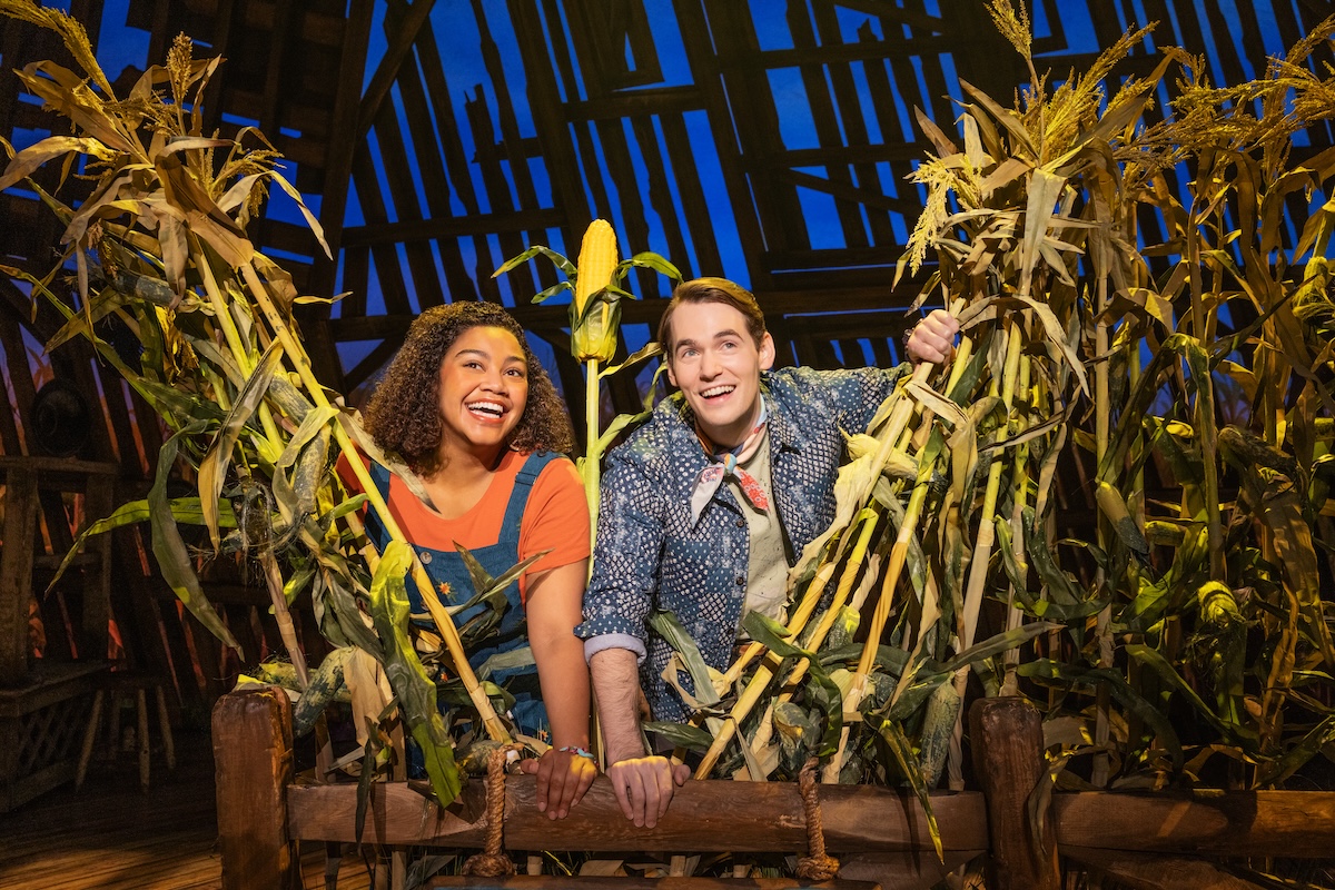 Maya Lagerstam as Storyteller 1 and Tyler Joseph Ellis as Storyteller 2 in The North American Tour of SHUCKED Photo by Matthew Murphy and Evan Zimmerman 0861 Maya Lagerstam as Storyteller 1 and Tyler Joseph Ellis as Storyteller 2. | Photo by Matthew Murphy and Evan Zimmerman 0861