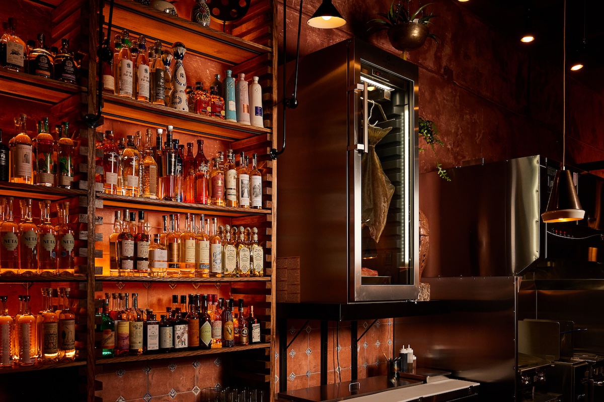 You can see the dry-age fish locker flanking the bar at Mezcaleria Alma. | Photo by Shawn Campbell